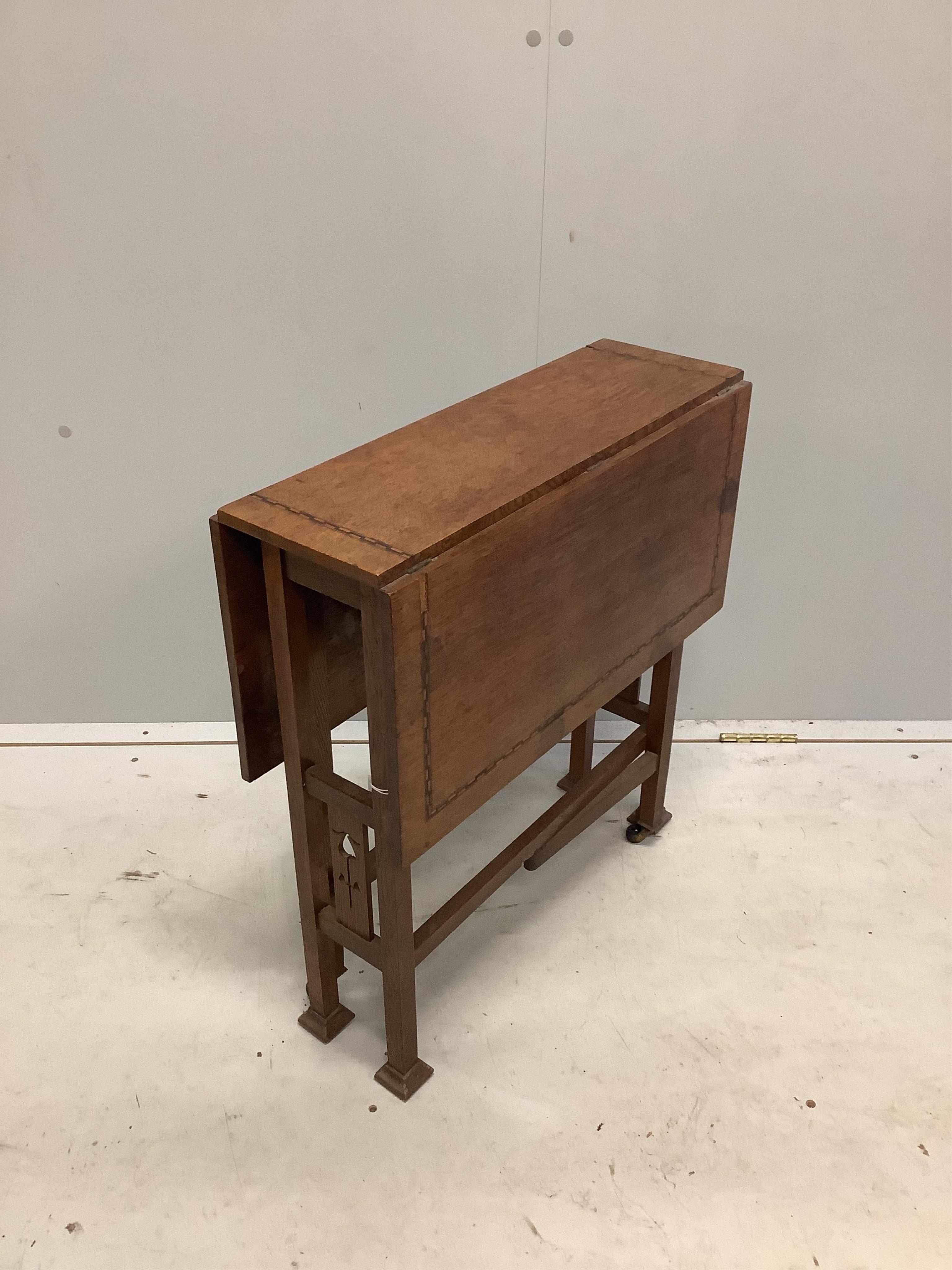 An Arts & Crafts inlaid oak Sutherland table, probably by Liberty of London, width 56cm, depth 20cm, height 60cm. Condition - fair